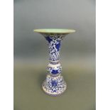 A Chinese porcelain two section Gu shaped vase with scrolling blue enamel lotus flower decoration,