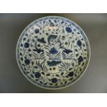 A large Chinese blue and white pottery charger with painted carp and lotus flower decoration, 15½"