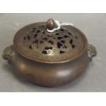 A Chinese bronze censer with pierced lid and raised lion mask handles, seal mark to base, 4½"