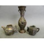 Two Chinese miniature bronze tea pots with cast decoration, and a Japanese bronze vase decorated