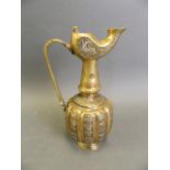 An Islamic polished bronze pourer with silver inlaid decoration, 8½" high (lacks lid)