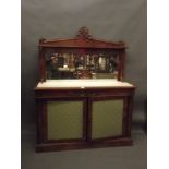 A Regency mahogany mirror backed chiffonier with two cupboards and carved applied decoration and