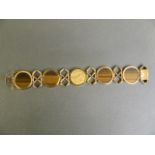 A fine 9ct gold five link bracelet set with an 1894 sovereign and four tiger's eye panels, 7" long