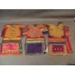 A collection of three Middle Eastern lady's silk dresses with mirror bead and embroidered