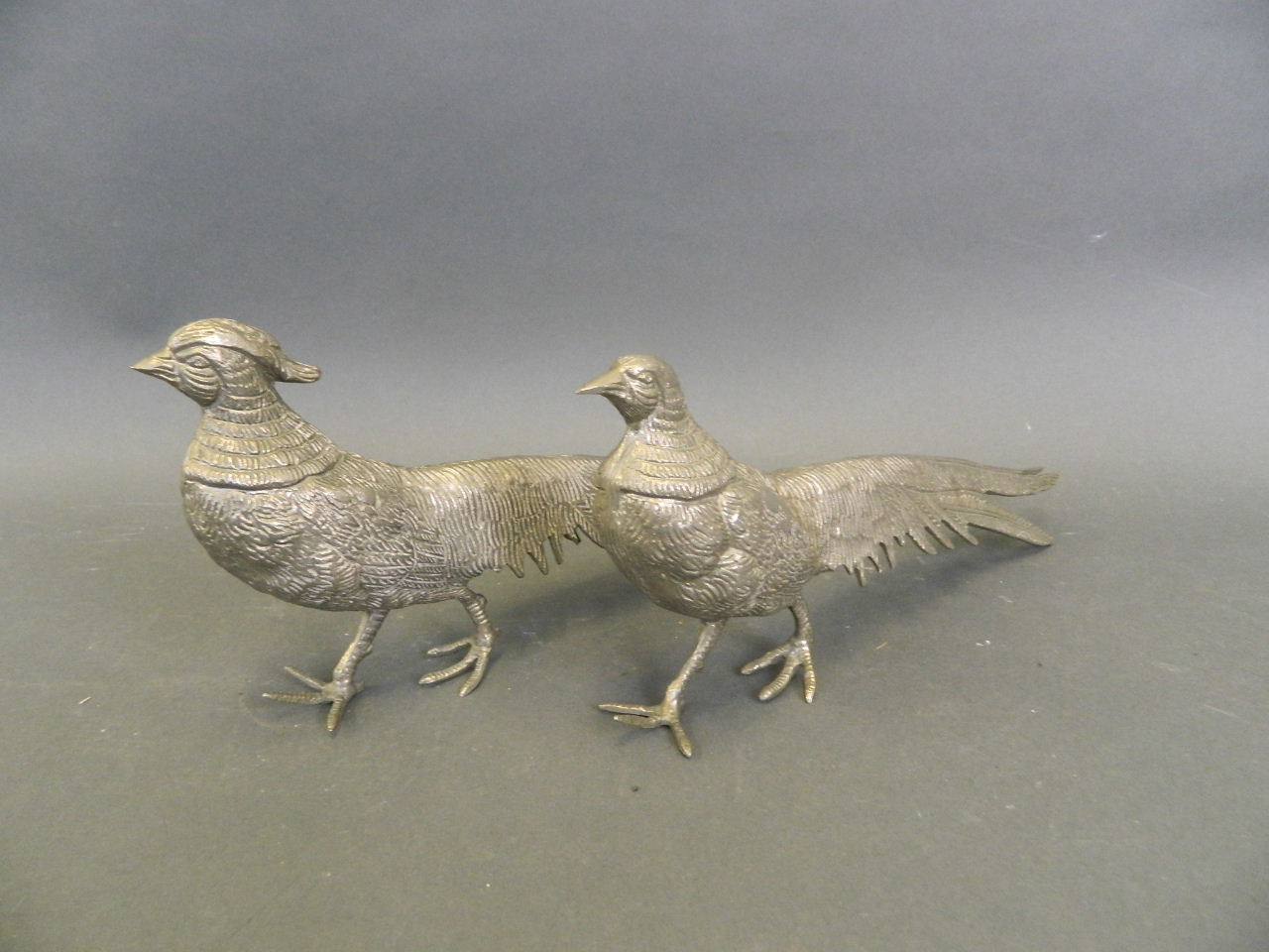 A pair of silvered metal Asiatic pheasants, 11" long