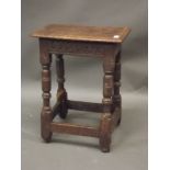 An early C17th oak joynt stool with chip carved frieze, raised on turned splayed supports