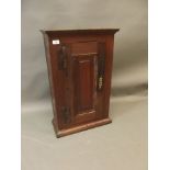 An early C18th oak spice cupboard with fielded panel door and iron 'H' hinges, 19" x 9" x 31"