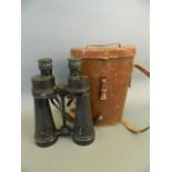A pair of WWII military binoculars by Barr & Stroud, in a leather case, 9½" long