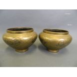 A pair of bronze Cario ware bowls with mixed metal inlay decoration, 5" x 7"