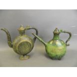 An Eastern bronze ewer with Islamic style moulded decoration and green patina, together with another