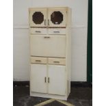 A mid C20th painted kitchen cabinet with two glazed cupboard doors over a fall front, 30! x 16" x