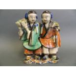 An antique Chinese stoneware figure painted in bright enamels of a seated couple , 7" high (AF)