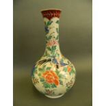 A Chinese long necked baluster vase decorated with birds amongst foliage in bright enamels, 14" high