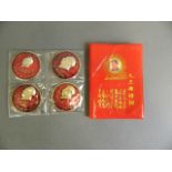 Four enamelled metal medals decorated with Chairman Mao, together with his red book, 3½" x 5"