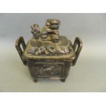 A Chinese cast iron incense burner with twin handles and Fo dog knop, 9" high