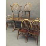 A set of six Ercol hoop back dining chairs, and an oak refectory table on carved baluster end