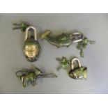 A collection of three bronze metal padlocks in the form of fish and Buddha with applied green