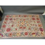 A large antique Uzbek white ground wall hanging with silk embroidered floral decoration, c1900,