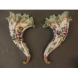 A pair of Continental porcelain cornucopia wall pockets with painted and gilded decoration