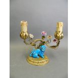 A gilt brass two branch candelabra with moulded flower and kylin decoration, converted to