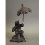 A bronze figure of a bear holding a parasol, 8" high