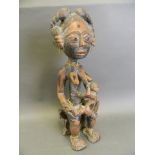 An African carved wood tribal figure of a woman and child, 18" high