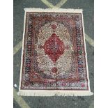 An ivory ground Kashmir rug with traditional medallion design, 46" x 60"