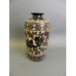 A Chinese Cizhou kiln porcelain vase with chased floral vine decoration, 10" high