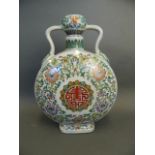 A Chinese twin handled porcelain moon flask with Doucai enamel scrolling lotus flower decoration,