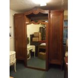 A late C19th/early C20th Italian inlaid walnut breakfront wardrobe with central mirrored door and