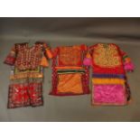 A collection of three Middle Eastern lady's silk dresses with mirror bead and embroidered