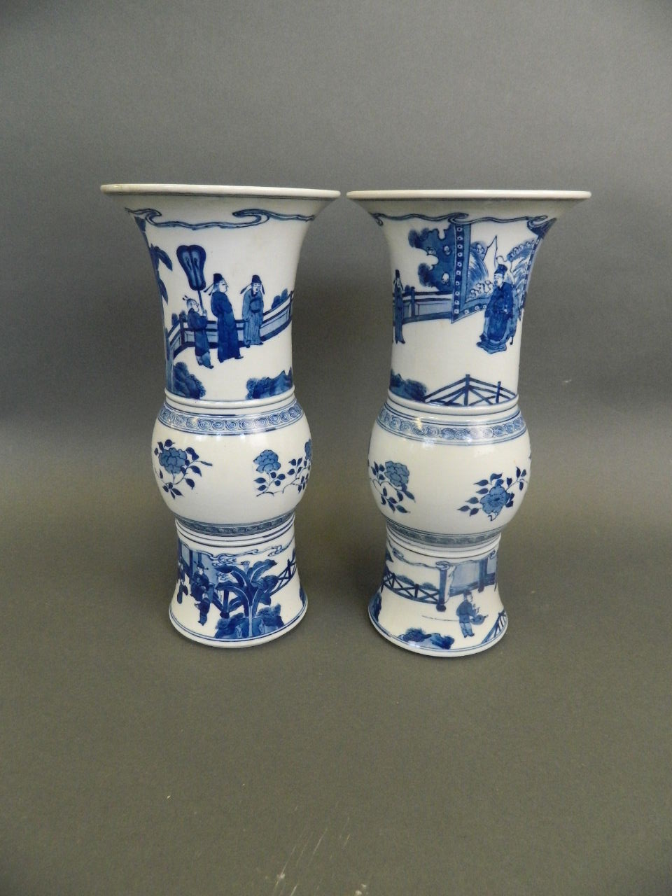 A pair of Chinese blue and white porcelain Gu shaped vases decorated with scenes of an emperor and