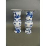 A pair of Chinese blue and white porcelain Gu shaped vases decorated with scenes of an emperor and