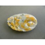 A Chinese mottled tri-colour jade pendant/scroll weight with carved twin kylin decoration, 3½" long