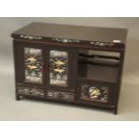 A Chinese black lacquer cabinet with finely inlaid mother of pearl and abalone decoration of
