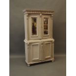 A small C19th Continental painted pine cabinet of two cupboards with mirrored panels over two