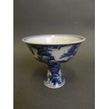 A Chinese blue and white porcelain stem cup with incised decoration of mythical creatures above