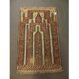 An Afghan woven prayer mat with geometric design, 28" x 44"