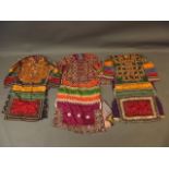 A collection of three Middle Eastern lady's silk dresses with mirror bead and embroidered