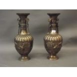 A pair of Japanese gilt bronze vases/lamps with raised decoration of birds amongst bamboo and cherry