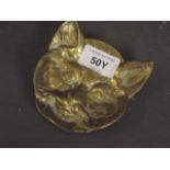 A brass ashtray in the form of a cat's head, 4" long