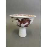 A Chinese red and white pottery stem cup with painted dragon decoration, 3½" high