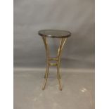 A contemporary brass and tinted glass jardiniere stand, raised on sabre supports, 14" x 29"