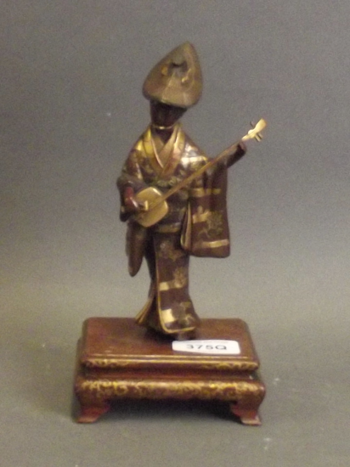 A fine Japanese Meiji period Miyao bronze figure of a woman playing a shamisen, with gilt