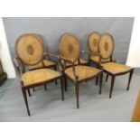 A set of six C19th Adam style walnut dining chairs with serpentine front rails and carved patera
