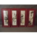 A set of four Chinese famille verte enamel panels depicting birds amongst foliage, mounted in
