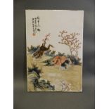 A Chinese famille verte porcelain plaque with enamelled decoration of rabbits, 10" x 14"