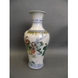 A Chinese famille verte porcelain vase with enamelled decoration of a fisherman and three