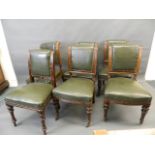 A matched set of six Victorian oak dining chairs with brass studded leatherette covers and carved