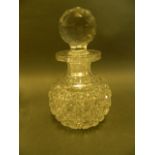 A facet cut glass perfume decanter with cut glass stopper, 6½" high